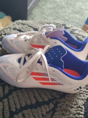 Adidas Kids White Soccer Cleats with Blue Lining and Red Accents